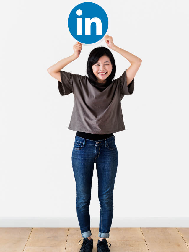 Lady smiling while holding linkedin logo on top of her head